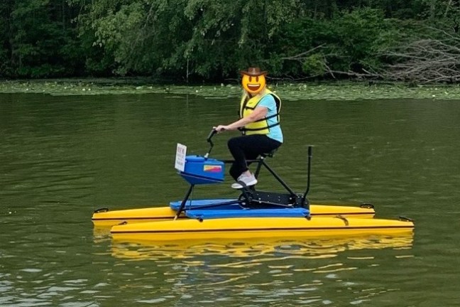 a man riding on the back of a boat in the water