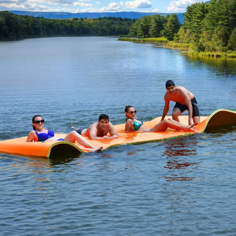 a group of people riding on the back of a boat in the water